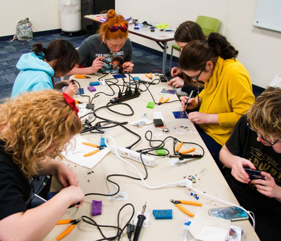 Photo showing assembling ArduTouch in an introductory workshop