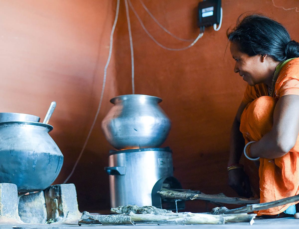 Photo showing woman with improved cookstove.
