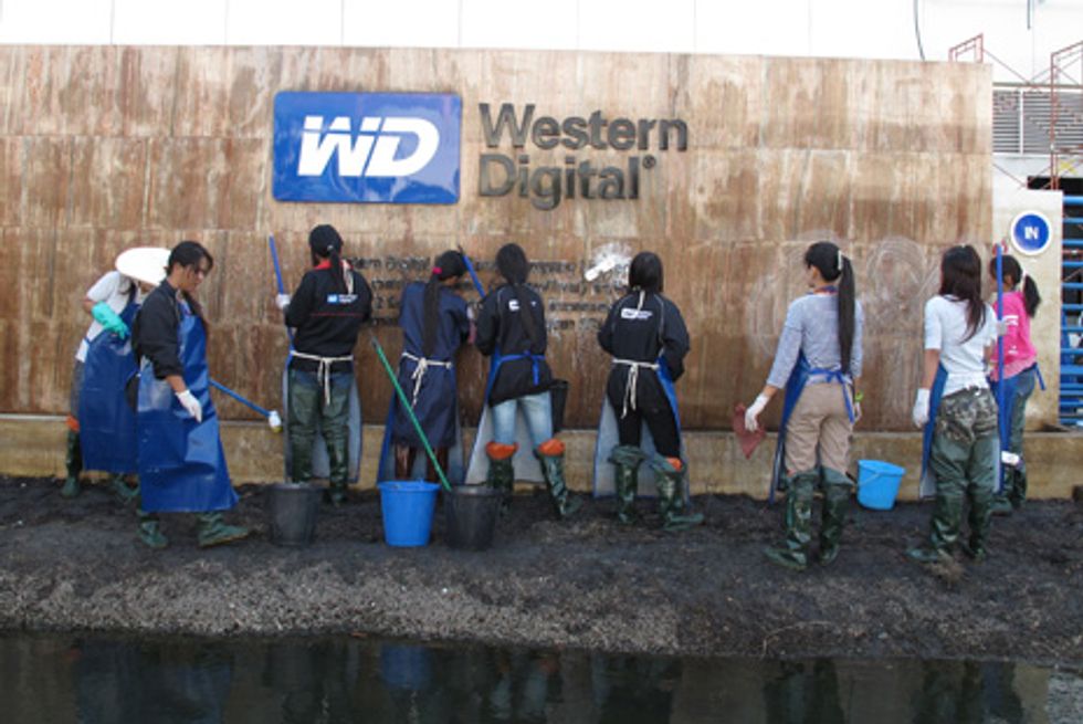 photo showing workers at Western Digital scrub away the residue of a 2011 flood