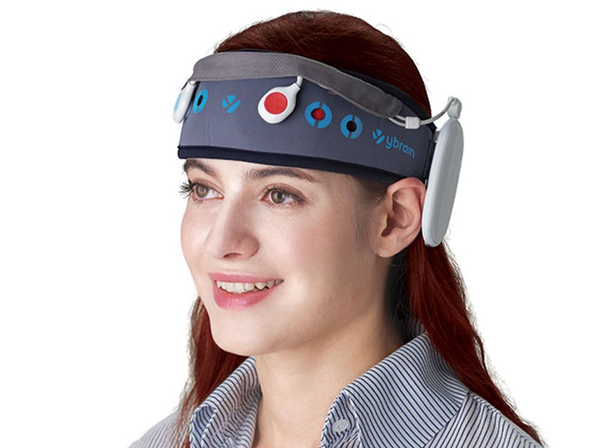 Photo shows a woman wearing a headband with embedded electrodes
