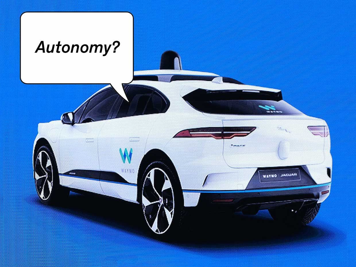 Photograph of a Waymo car on a screen. A speech bubble says Autonomy?