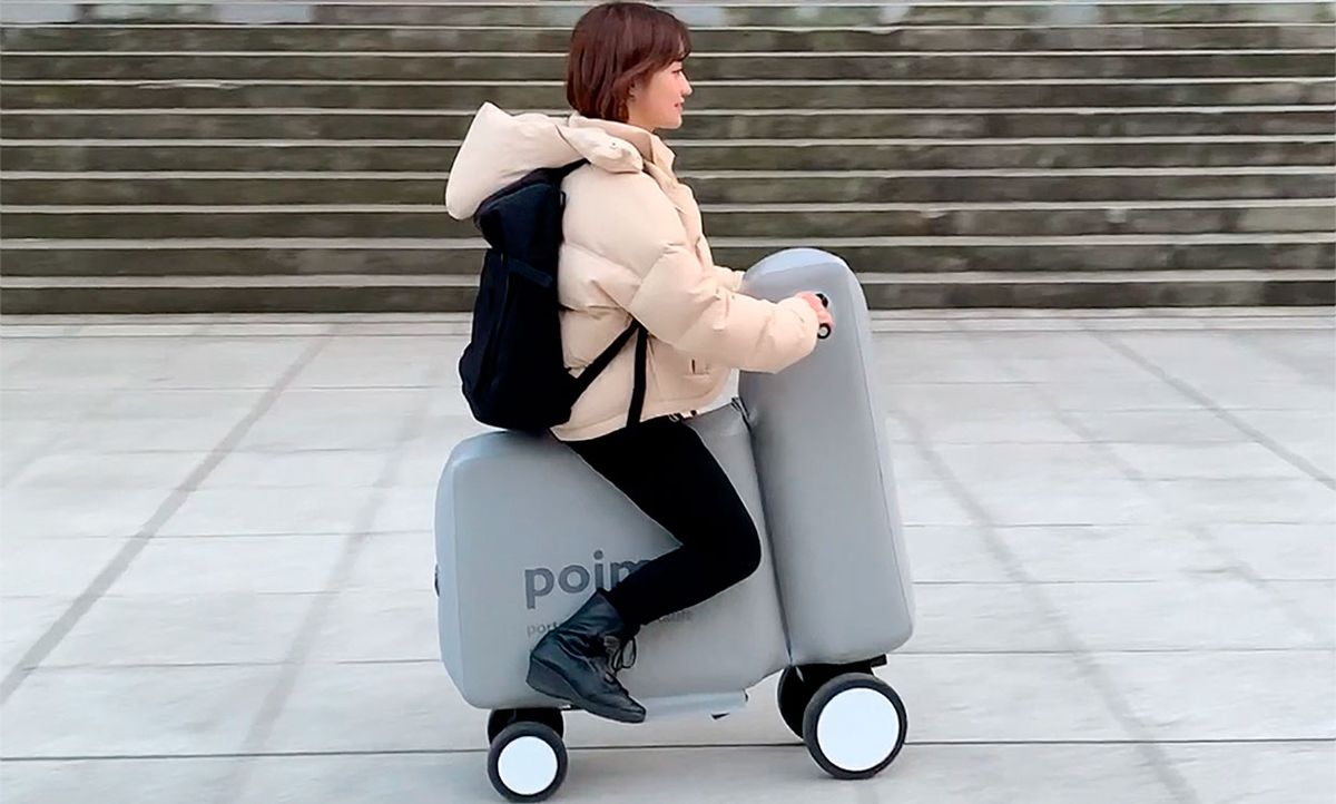 Photograph of a woman riding the Poimo (POrtable and Inflatable MObility) inflatable e-bike.