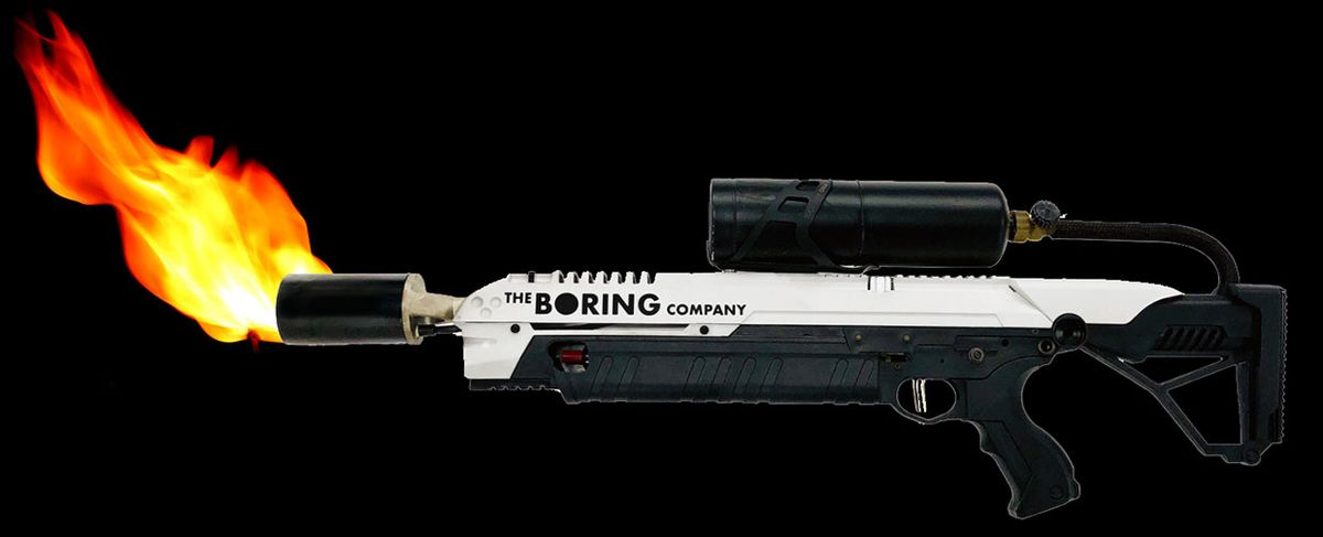 Photograph of The Boring Company's flamethrower with a flame coming out of the tip.