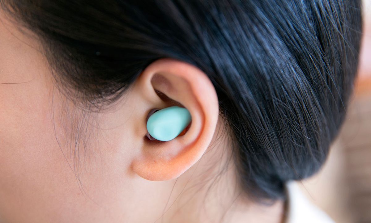 Photograph of the Yono wearable in a woman's ear.