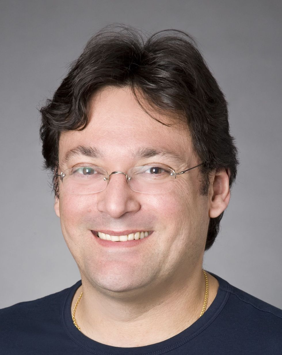 Portrait of NYU researcher Claudio Silva smiling at the camera