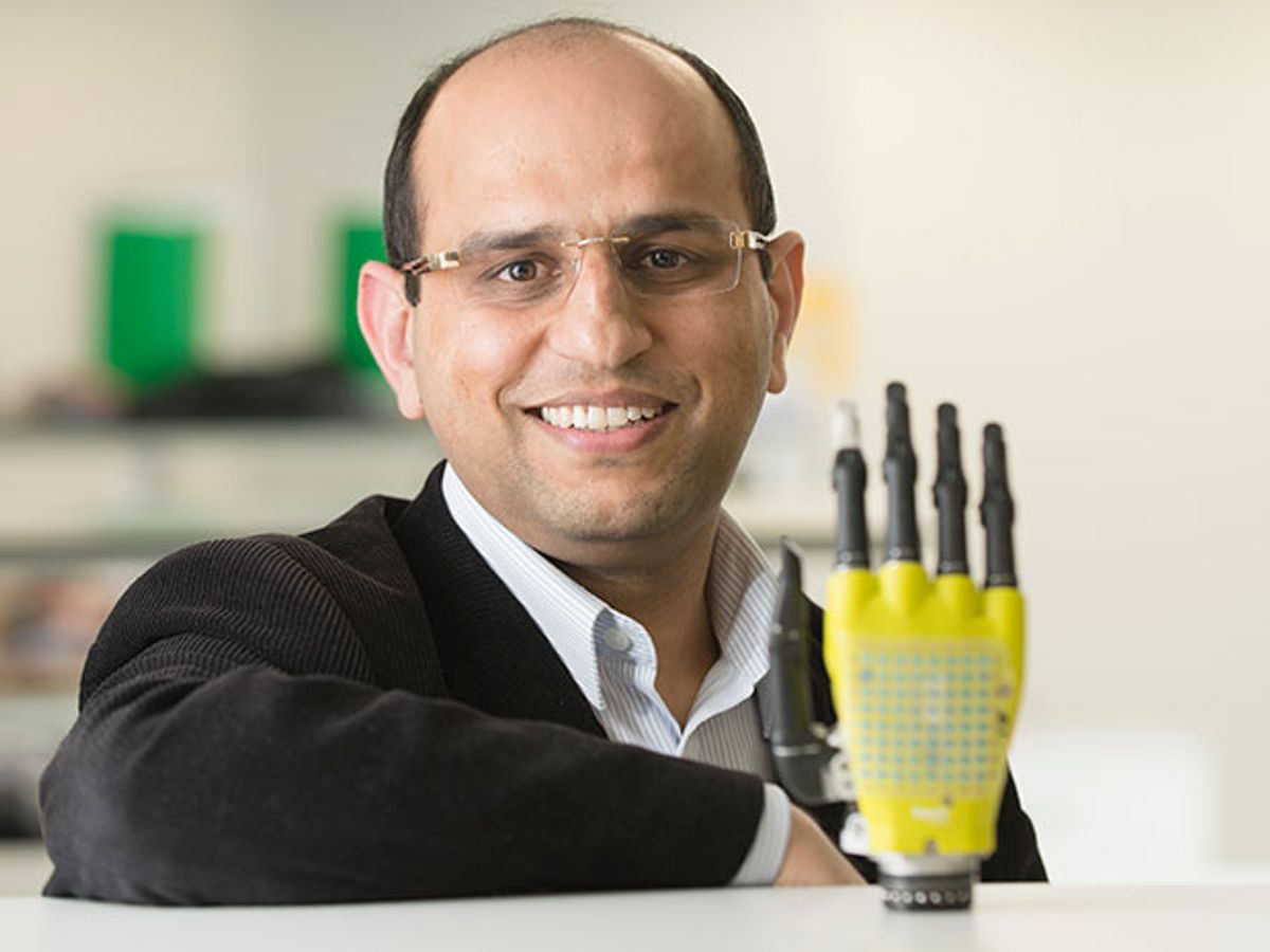 Ravinder Dahiya and a prosthetic hand clad in solar-powered graphene skin.