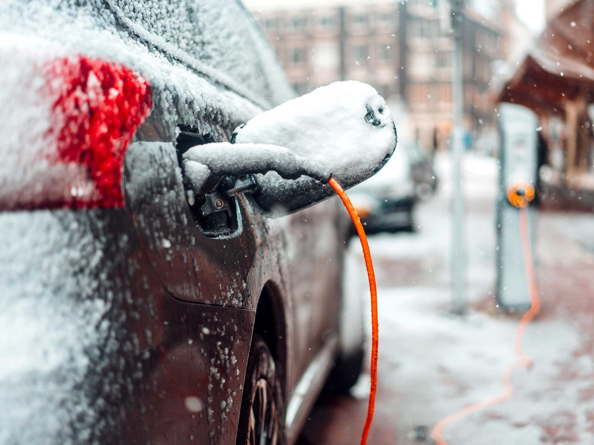 rear view of a car charging with snow and ice on it