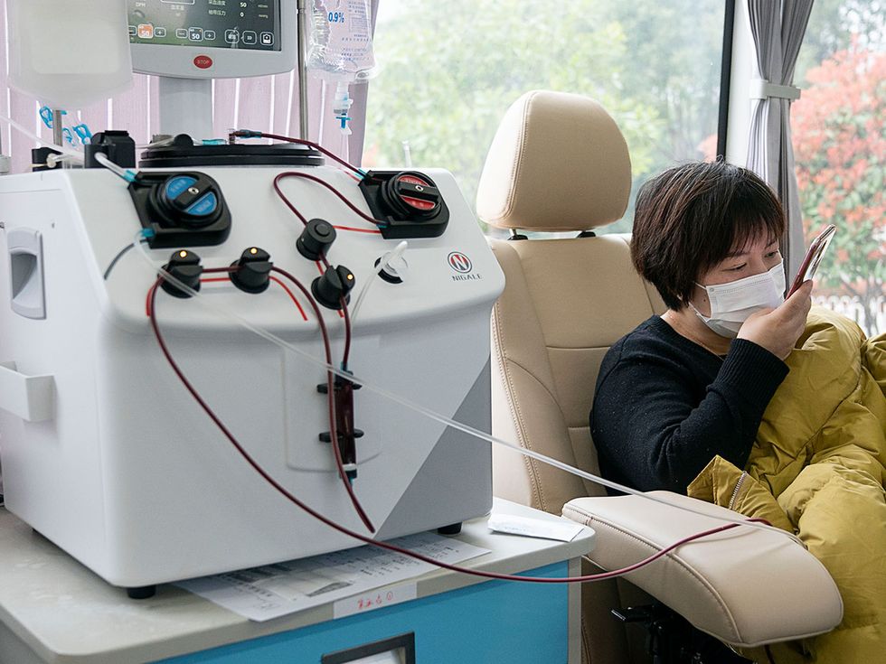 Recovered COVID-19 patient Zheng Yongheng donates plasma at a mobile hospital in Wuhan, central China's Hubei Province, March 12, 2020.