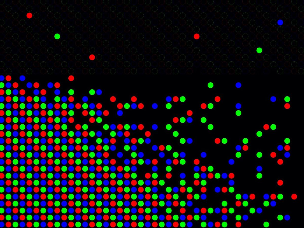 Red blue and green dots mass in rows, with some dots moving away