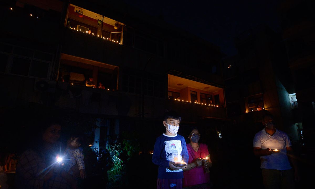 Residents light up candles and diyas to observe nine minutes of unity and solidarity as called by PM of India, to fight against dangerous Corona Virus in Country.