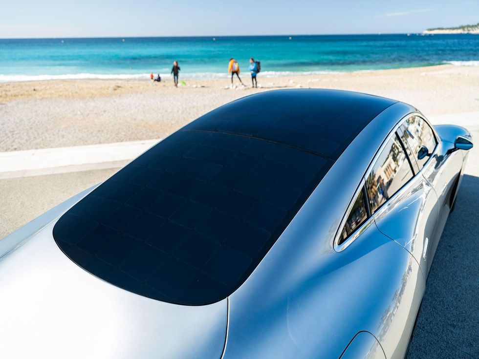 Roof of a car with solar panels with a beach in the background.