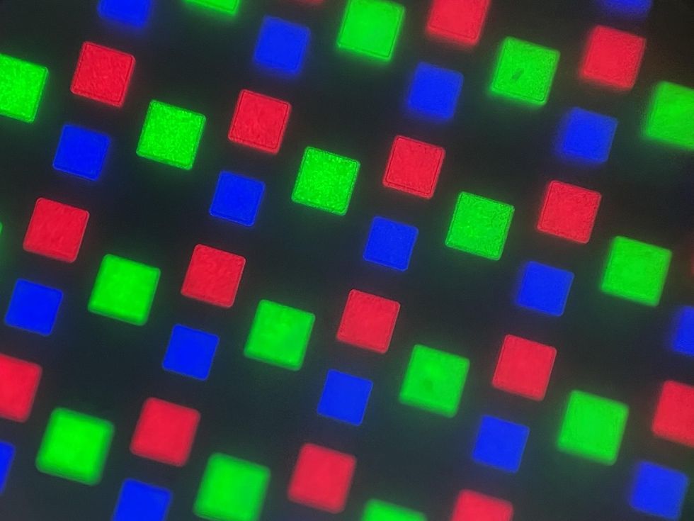 rows of green squares alternating with rows of red and blue squares against a black background
