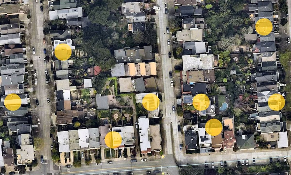 Satellite image with solar panels highlighted with yellow circles.