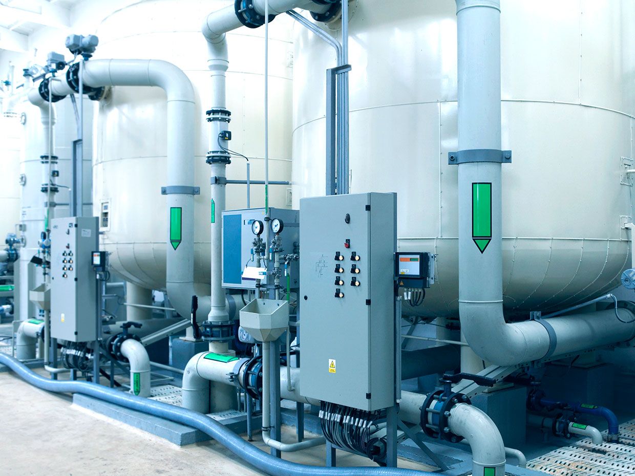 Detail of water cleaning plant: large filters (canisters), pipelines and electronics switchboards