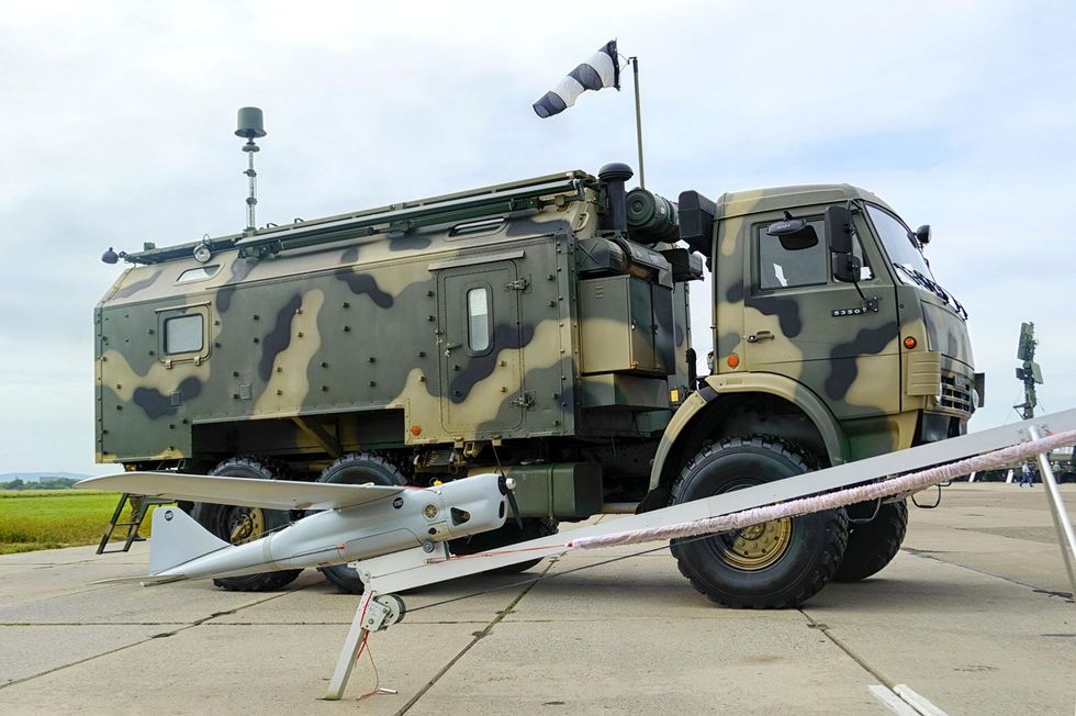 side profile of an orlan 10 drone and a LEER-3 Russian military vehicle