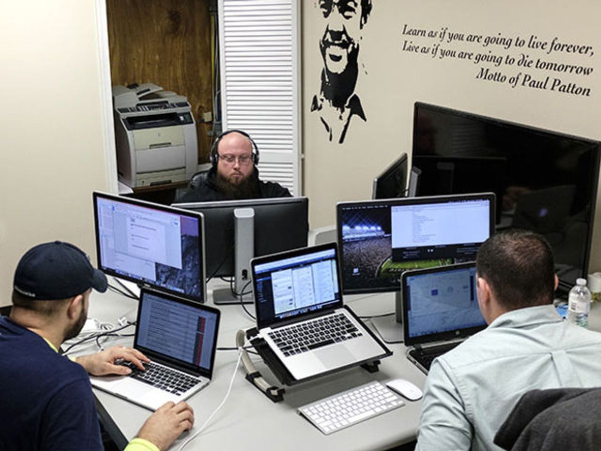 Software coders William Stevens, from left, Michael Harrison, and Brack Quillen work on computers at the Bit Source LLC office in Pikeville, Kentucky, U.S., on Monday, Feb. 1, 2016.