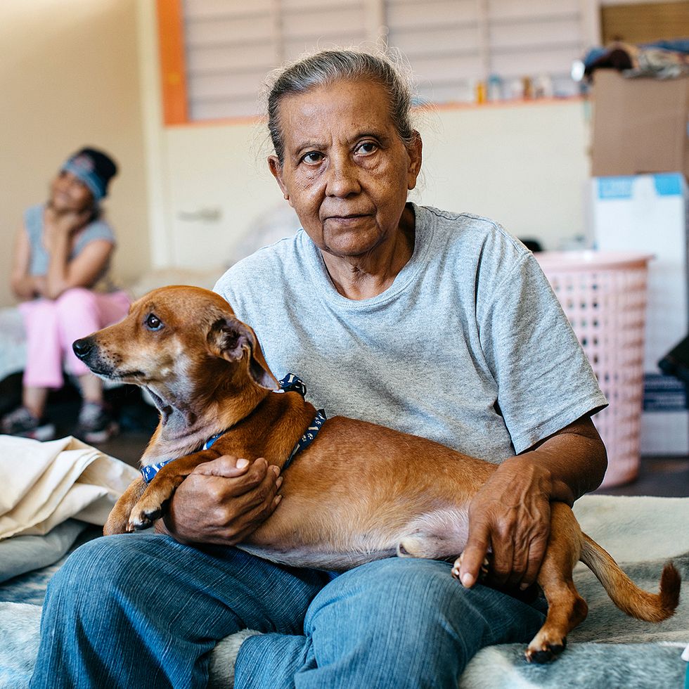 Sol R\u00edos and her dog, Chivi, in a shelter in Maricao.
