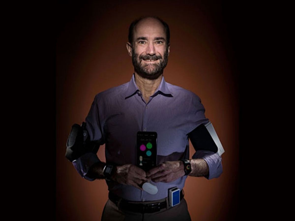 Stanford research Michael Snyder poses laden with the wearable gadgets that recently helped him realize he'd been infected by Lyme disease before he showed symptoms