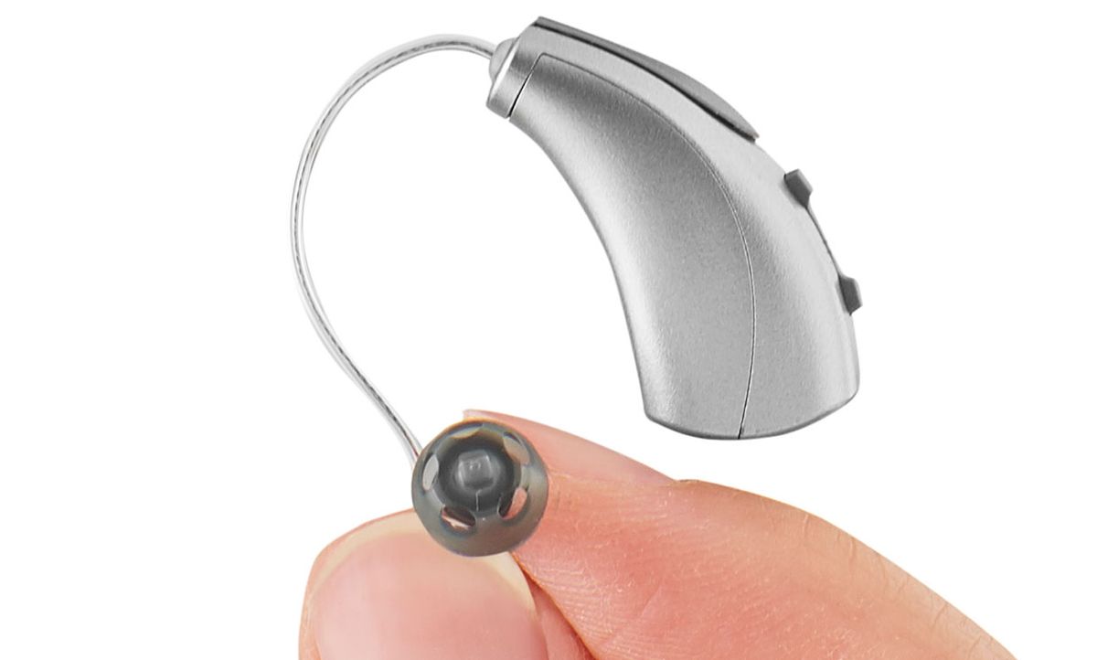 Starkey's Livio AI hearing aid, held in a hand.