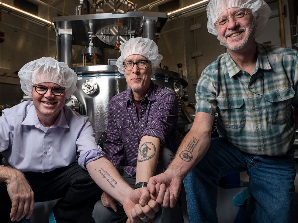 Stephan Schlamminger, Jon Pratt, and David Newell show off their tattoos.