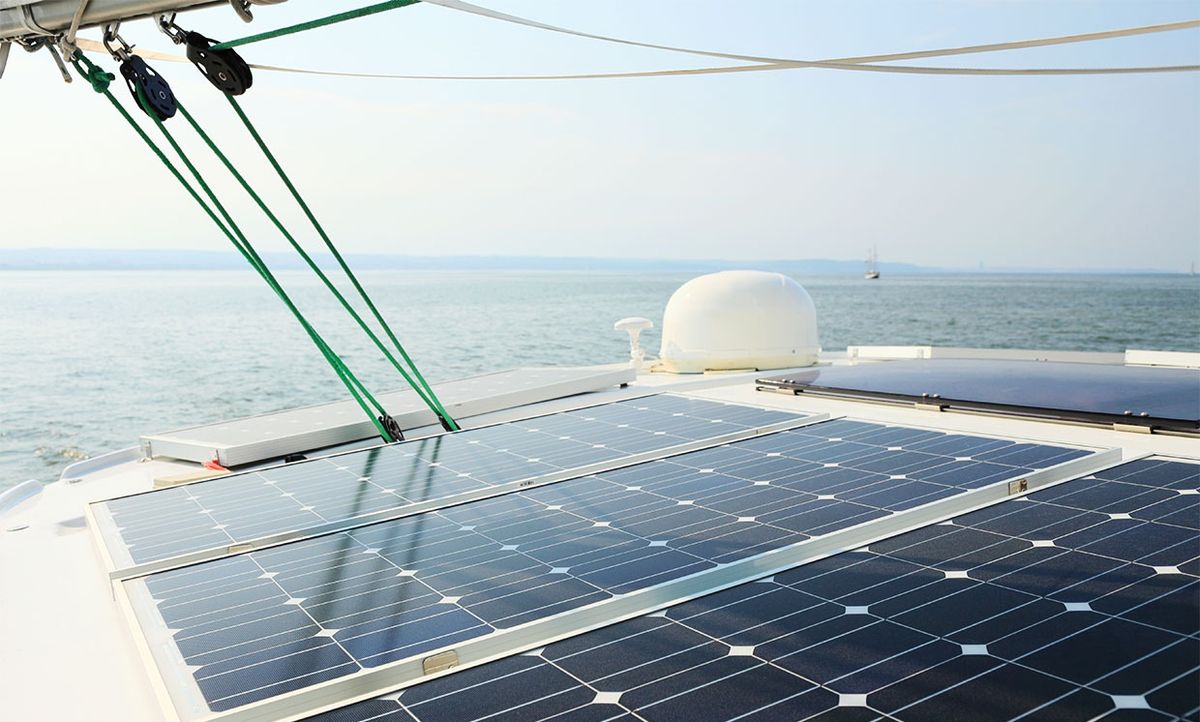 Stock photo of a boat with photovoltaic solar panels on it.