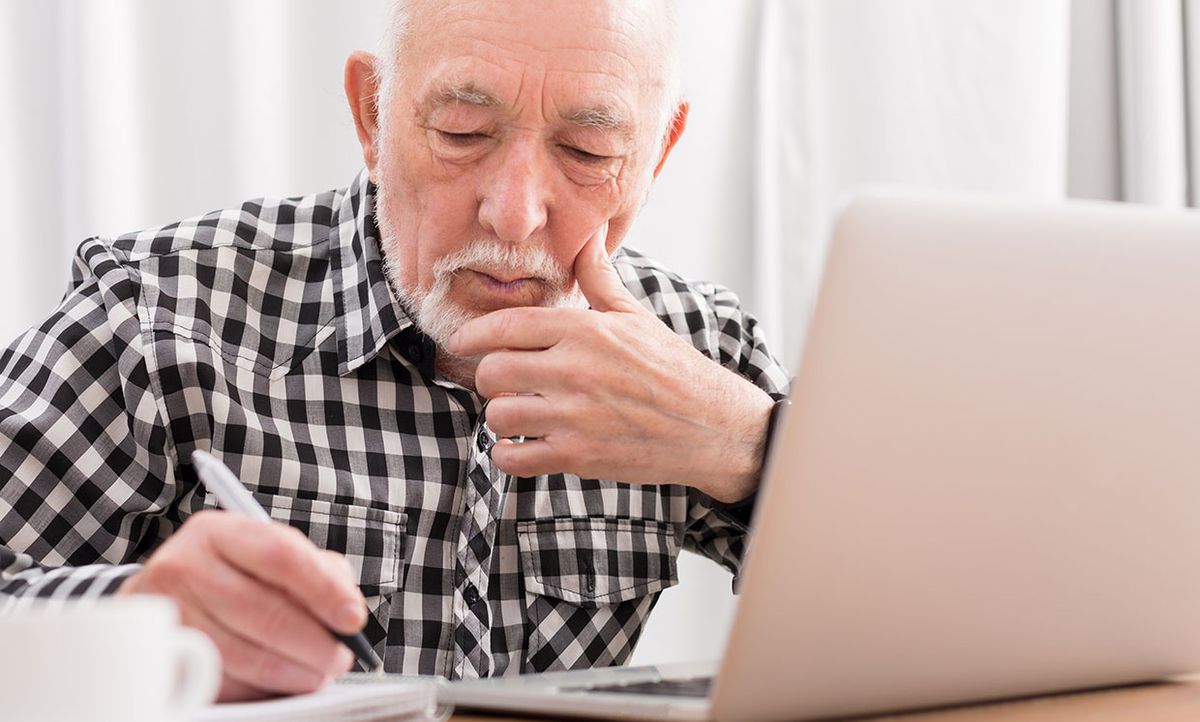 Stock photo of a senior man working on a computer