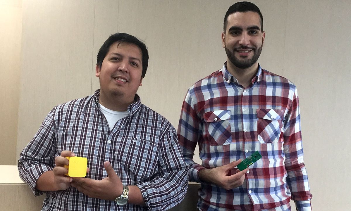 Sucre Cando and Nassim Bettach hold parts of a prototype wildfire detection sensor