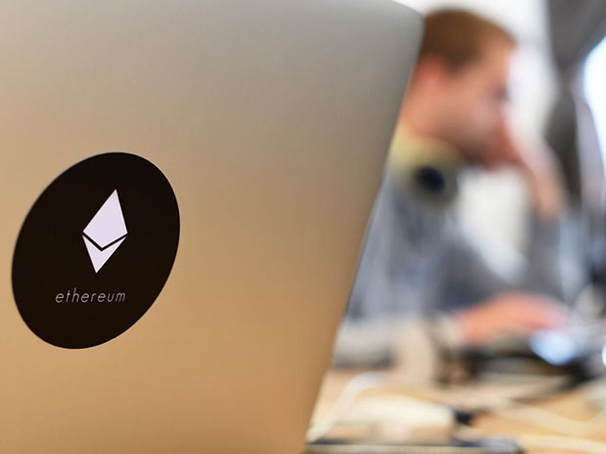 Symbol of Ethereum on the back of an open laptop. Ethereum uses blockchain technology to build virtual companies and other services.