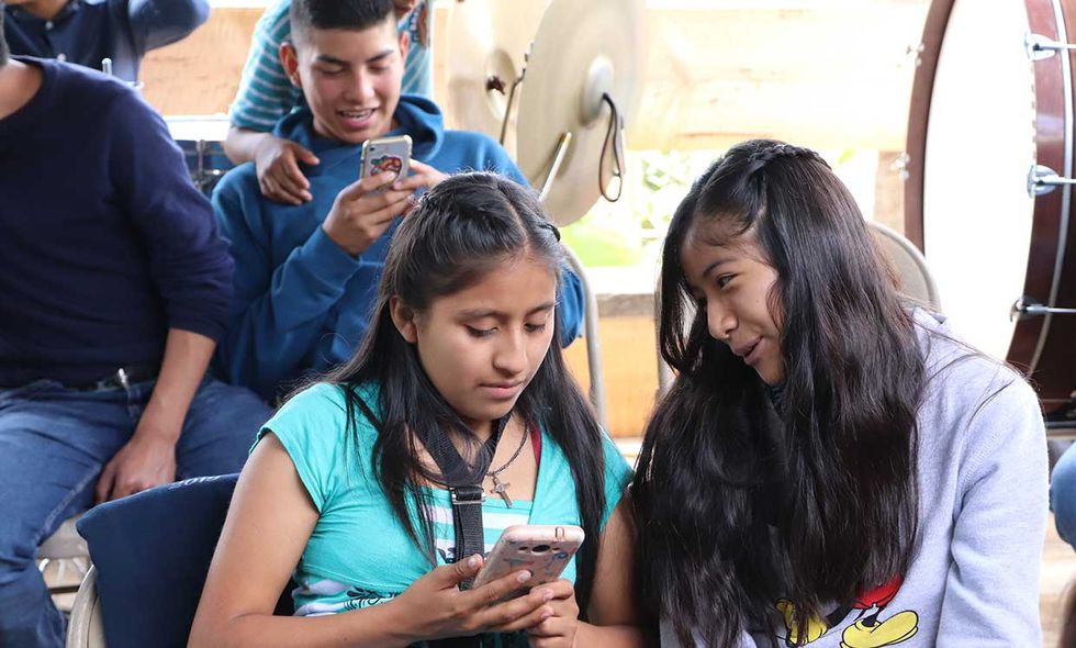 Talean youth on their cell phones