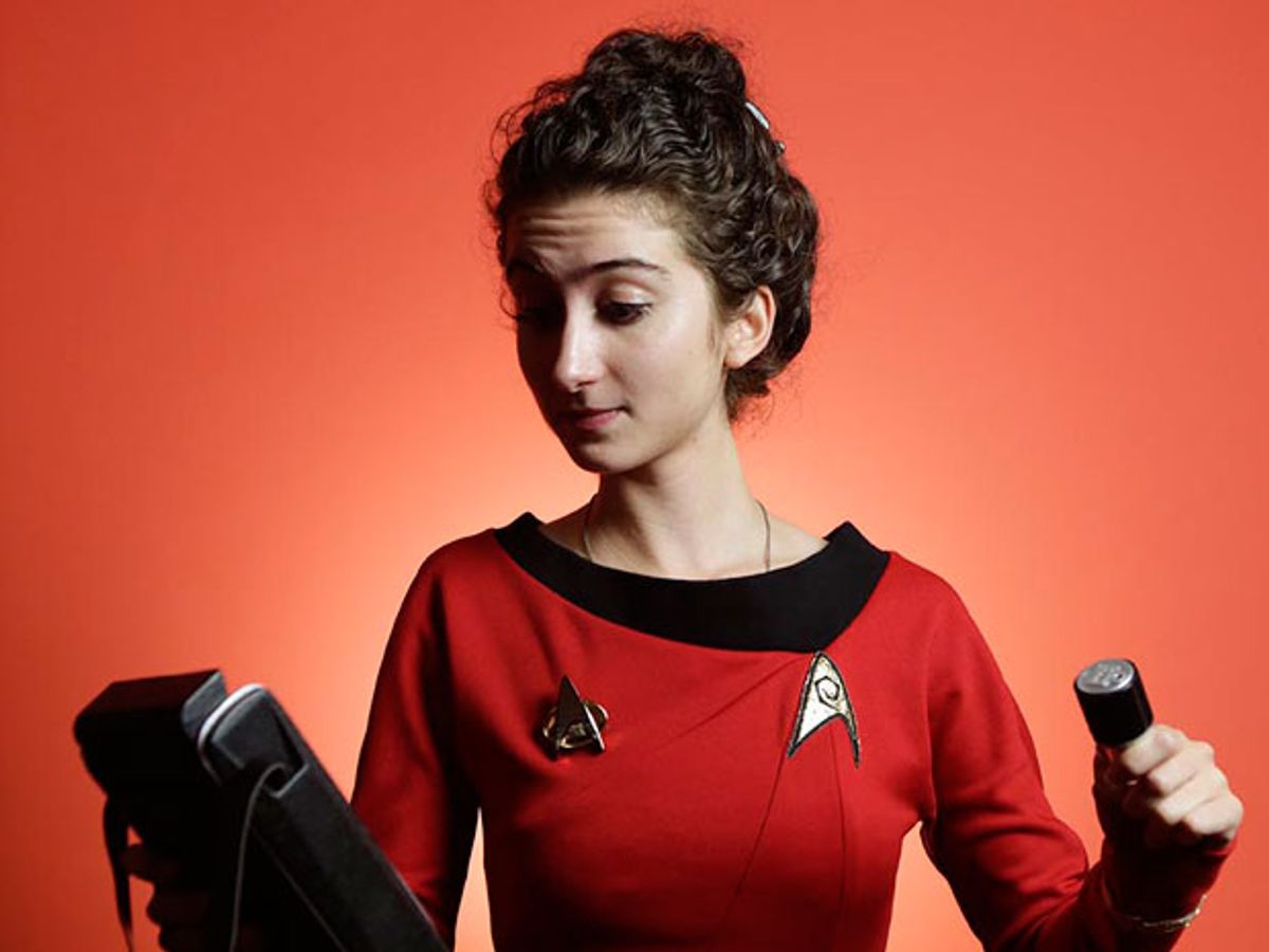 Tatiana Rypinski, dressed in "Star Trek" gear, holds a replica tricorder