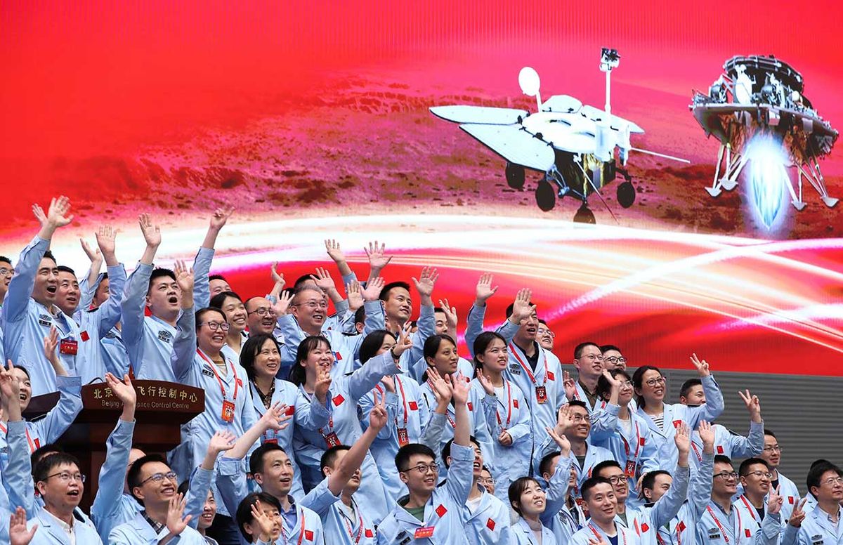 Technical personnel celebrate after China's Tianwen-1 probe successfully landed on Mars at the Beijing Aerospace Control Center in Beijing, capital of China, May 15, 2021.
