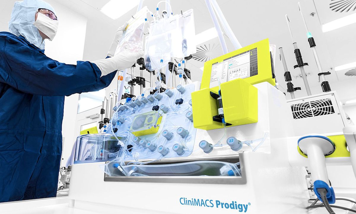 Technician with the Miltenyi Biotec tabletop CliniMACS Prodigy device that takes in a patient’s cells and automatically moves them through several steps required to produce a CAR-T treatment.