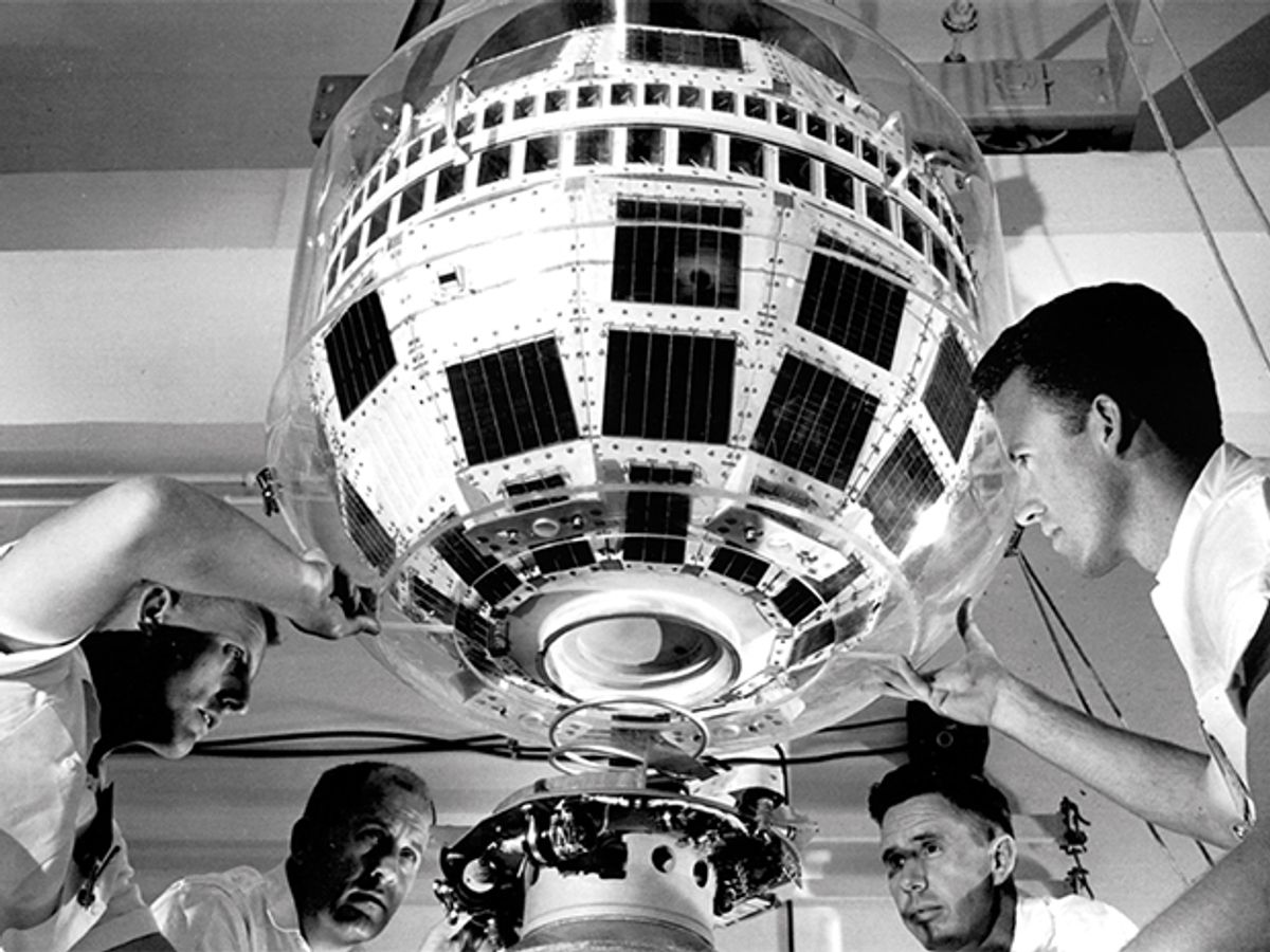 Technicians attach the 77-kilogram Telstar 1 satellite to a launching rocket for its journey into orbit in 1962.