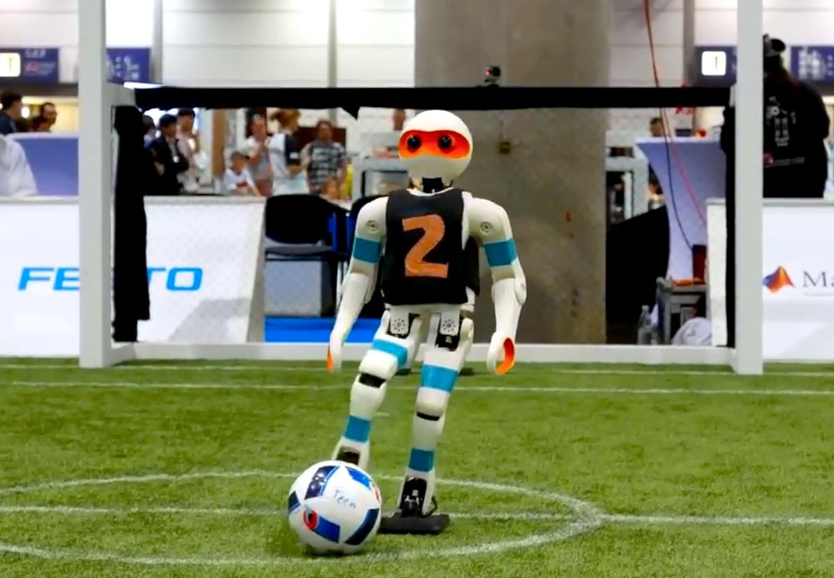 Teen size humanoid robot kicks ball at RoboCup