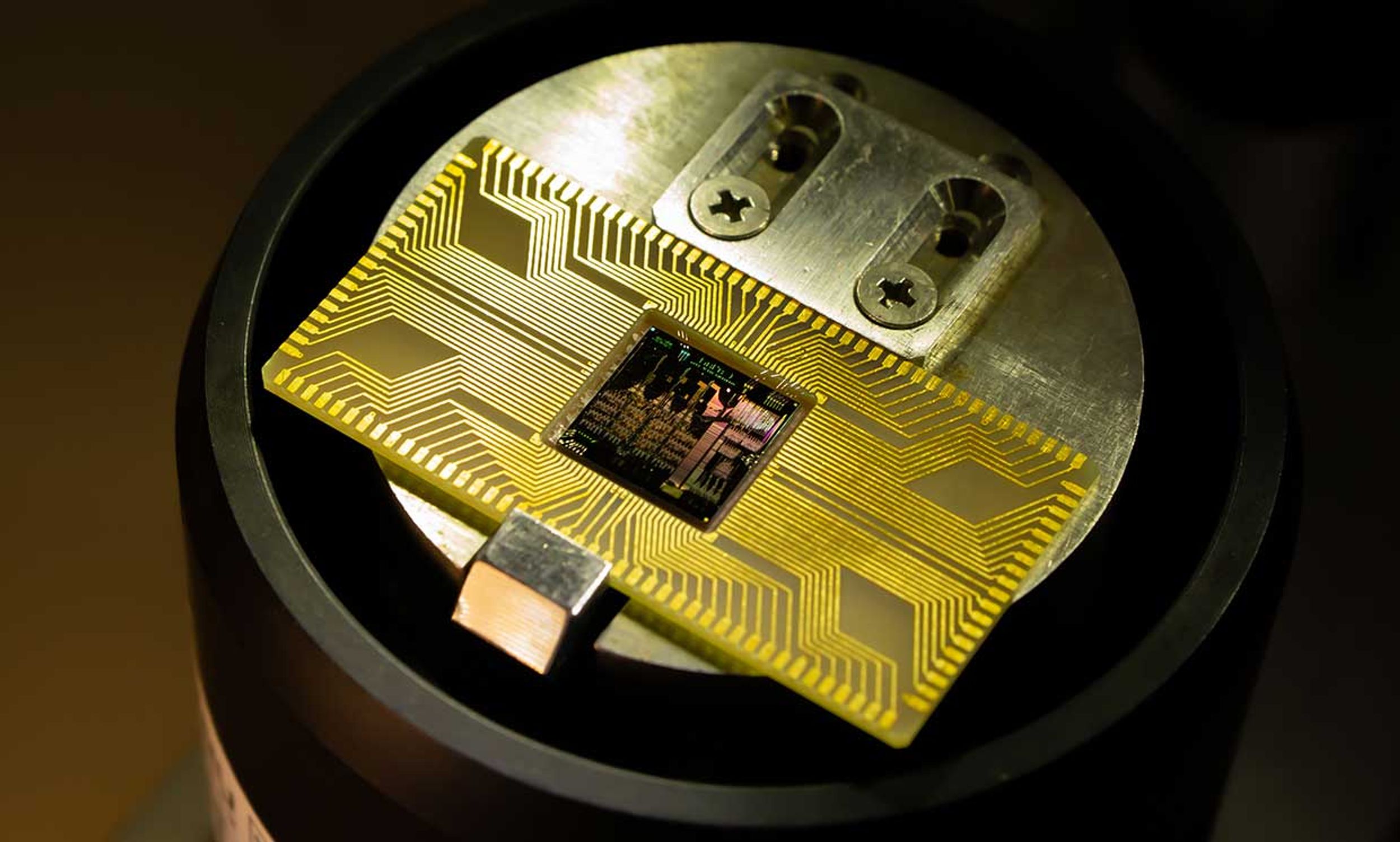 The AQFP-based MANA microprocessor seated on a chip holder.