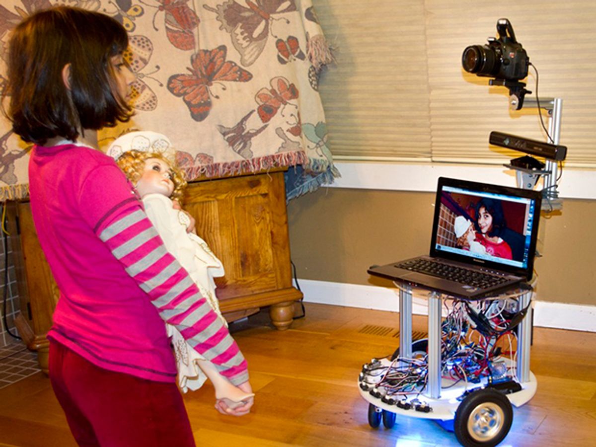 The author’s 8-year-old interacting with Microsoft's Roborazzi, a mobile robot photographer.