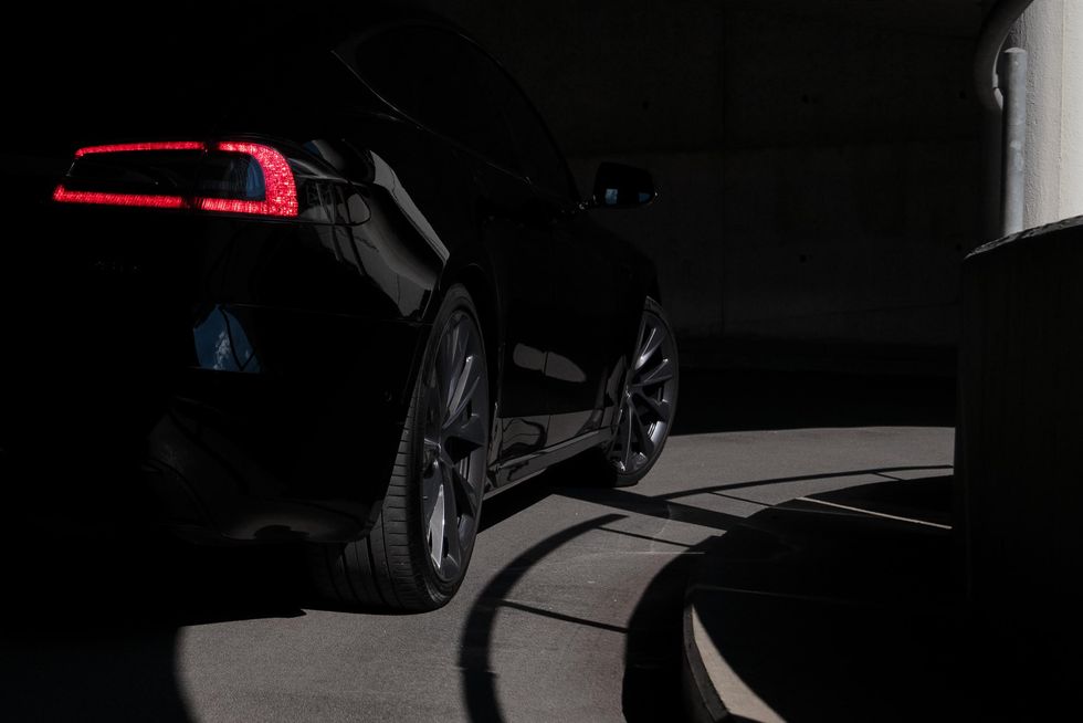 The back of a Tesla Model S seen in shadow