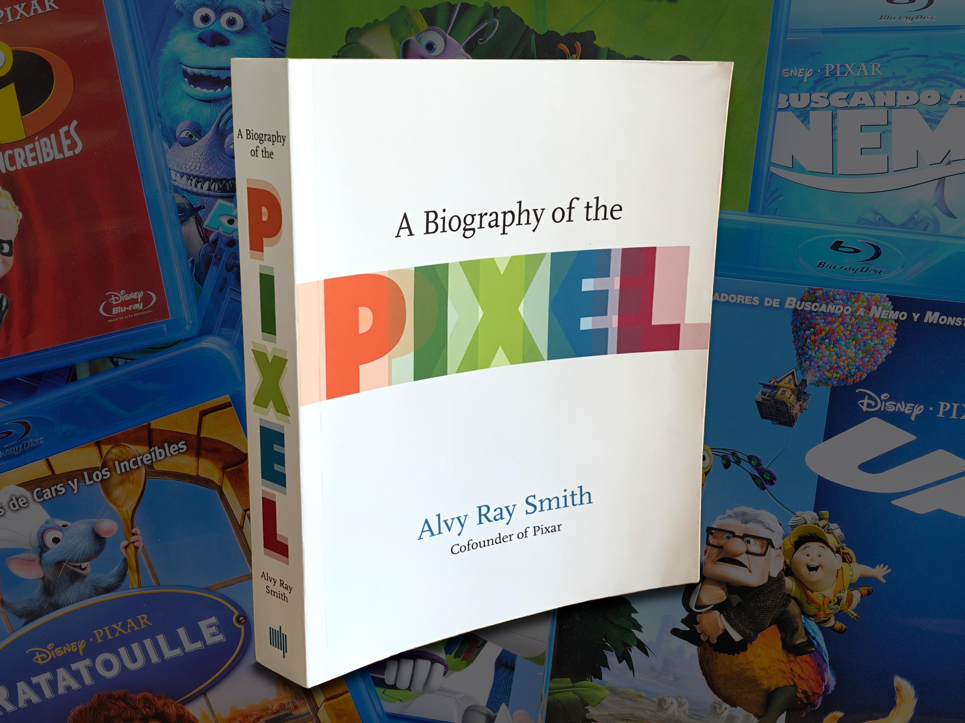 The book A Biography of the Pixel by Alvy Ray Smith atop a background of Pixar Blu-Ray cases