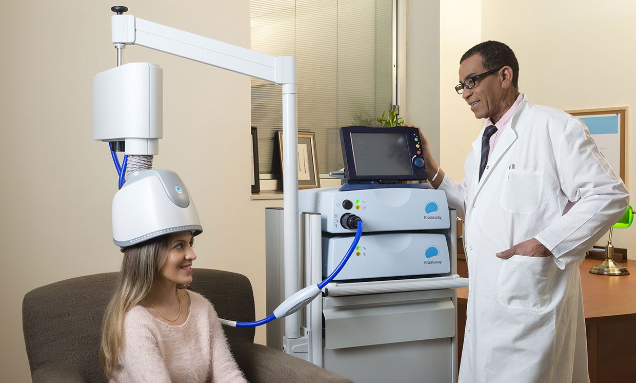 The BrainsWay device used on a patient, with a doctor nearby.