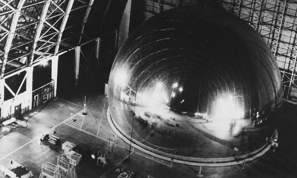 The company that built NASA\u2019s balloon satellites also built the pavilion\u2019s spherical mirror. A full-scale prototype of the mirror is shown here at an airbase in Southern California. 