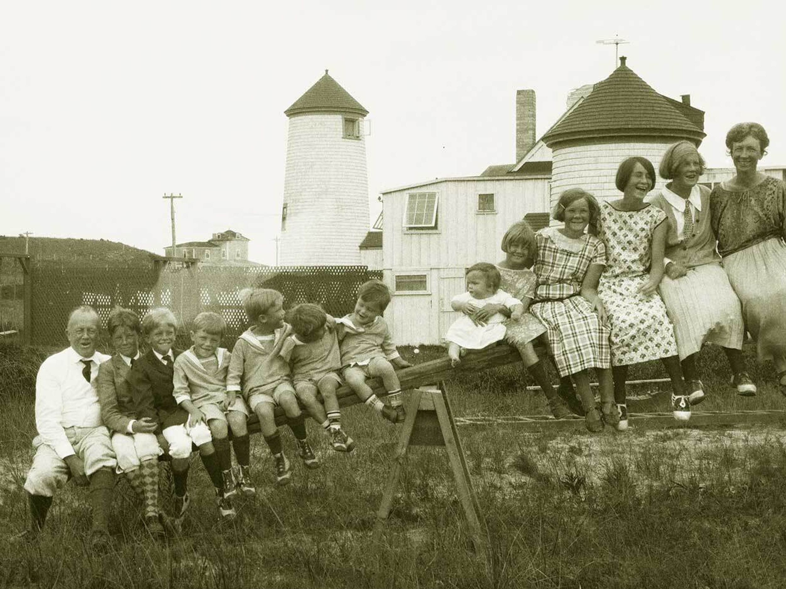 The Gilbreth family sits atop a see-saw while they spend their 1923 summer in an old lighthouse on Nantucket Island.