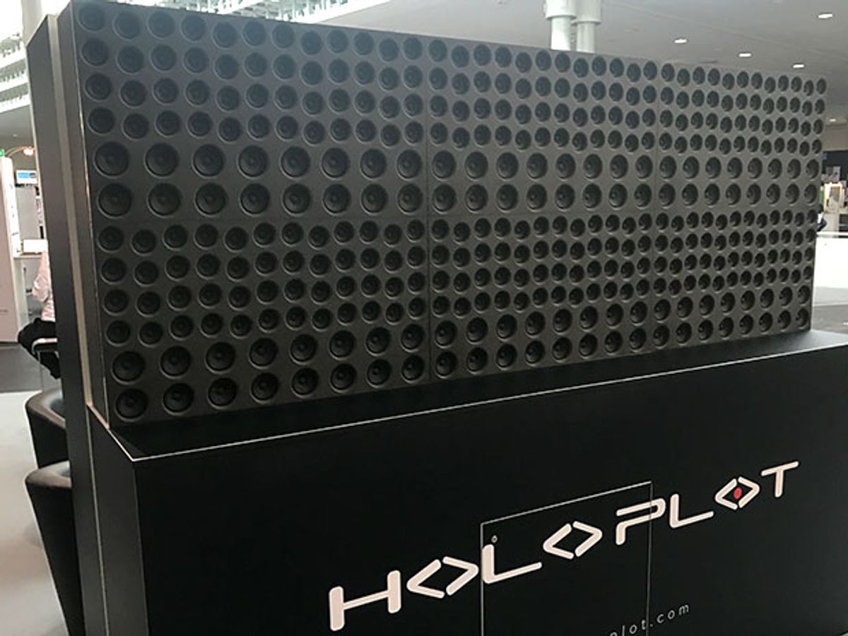 The Holoplot audio system, a large array of black speakers, looks like a large black rectangle with hundreds of depressions of different sizes within. It is displayed at CeBIT, an annual trade show in Hanover, Germany.