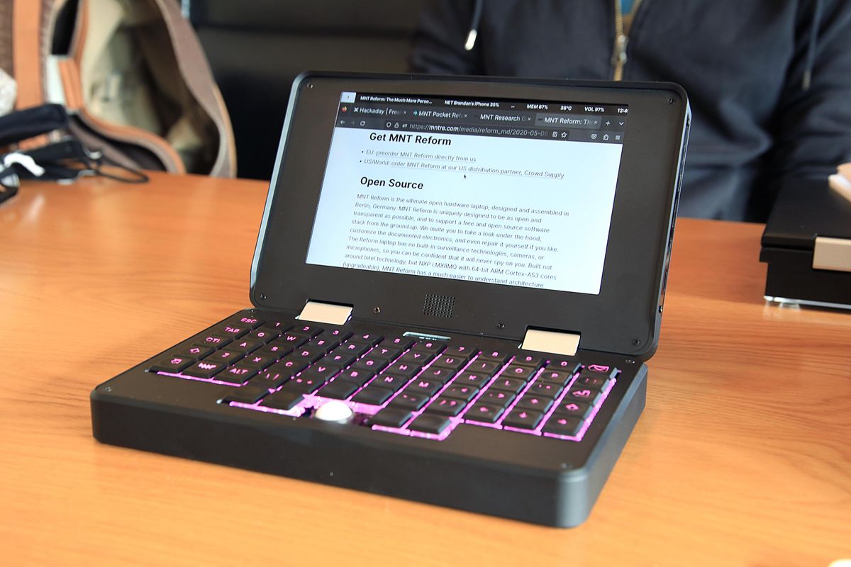 The MNT Reform Pocket computer open on a table and displaying a web page.