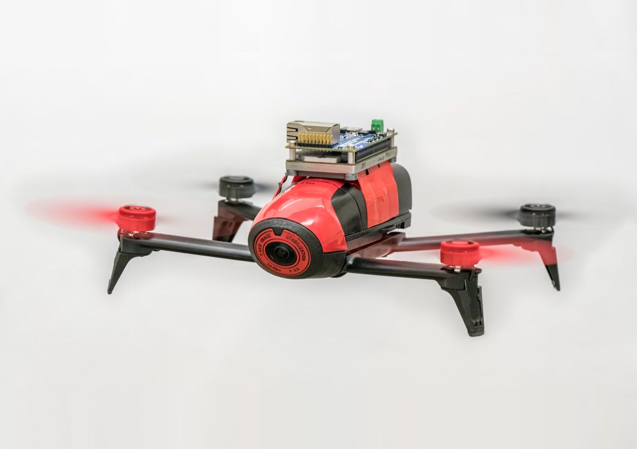 The modified drone used in UMD's experiments includes a NVIDIA TX2 module mounted at the top. For sensing, the drone uses its front-facing camera and a downward-facing optical-flow sensor, which combines a camera plus sonar.
