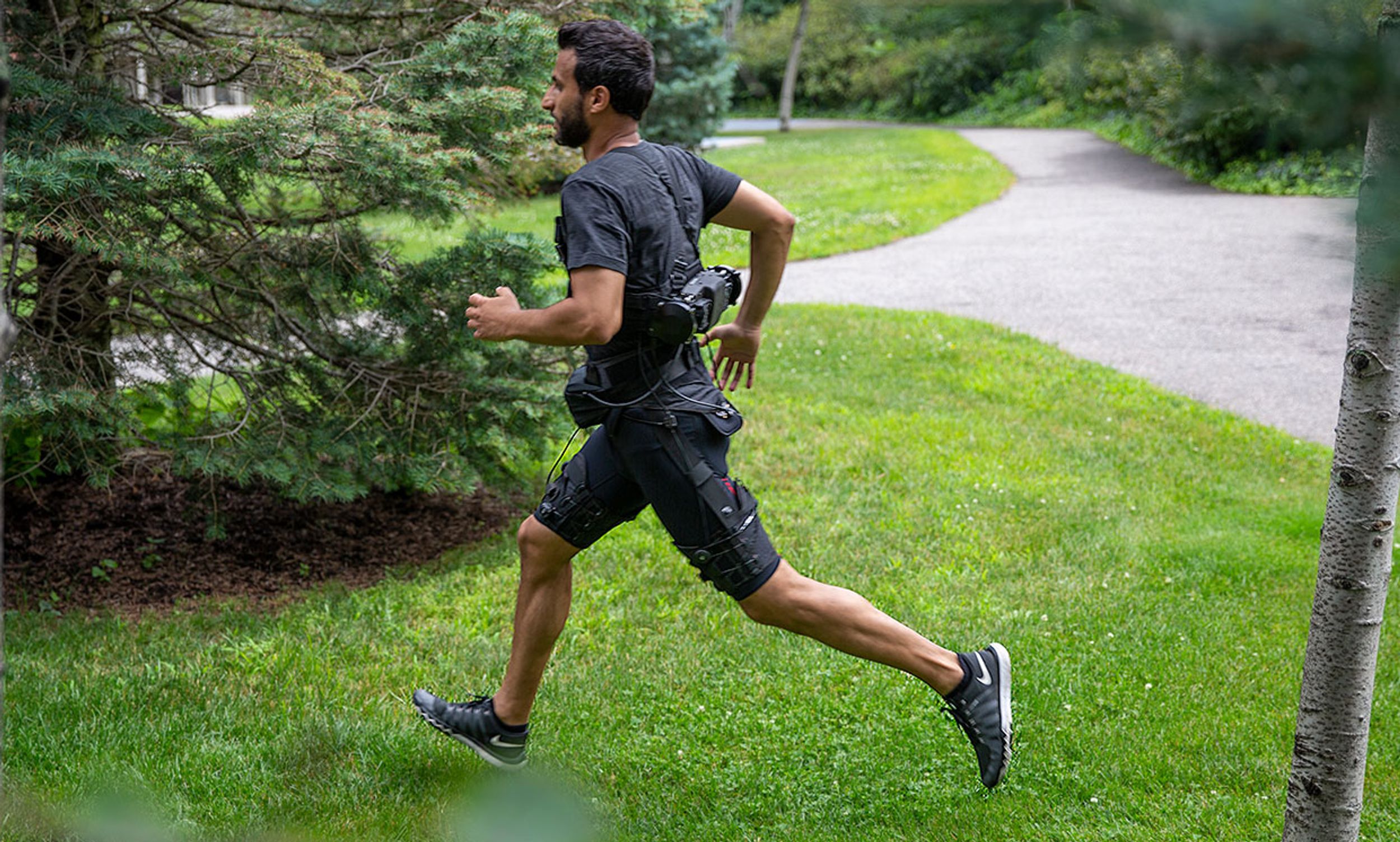 The portable exosuit is made of textile components worn at the waist and thighs, and a mobile actuation system attached to the lower back which uses an algorithm that robustly predicts transitions between walking and running gaits.
