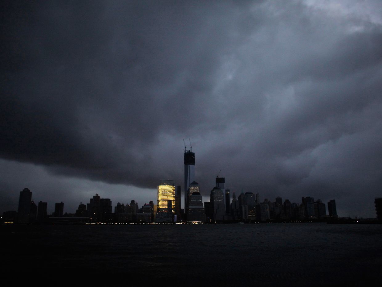 The skyline of lower Manhattan is mostly dark except for one office building after a blackout caused by Superstorm Sandy on 30 October 2012.