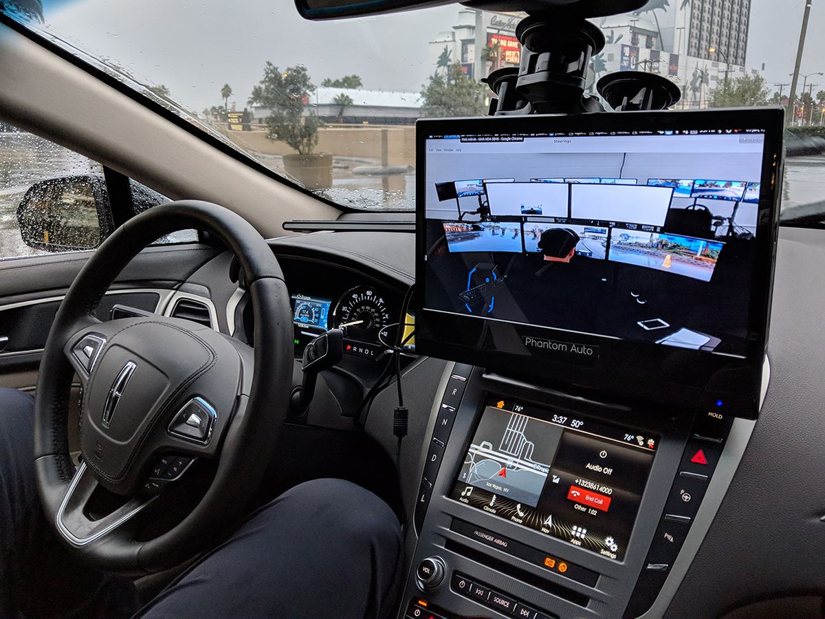 The view inside a Phantom car shows a hands free passenger in the driver's seat, as well as a special display showing the remote driver of the car.