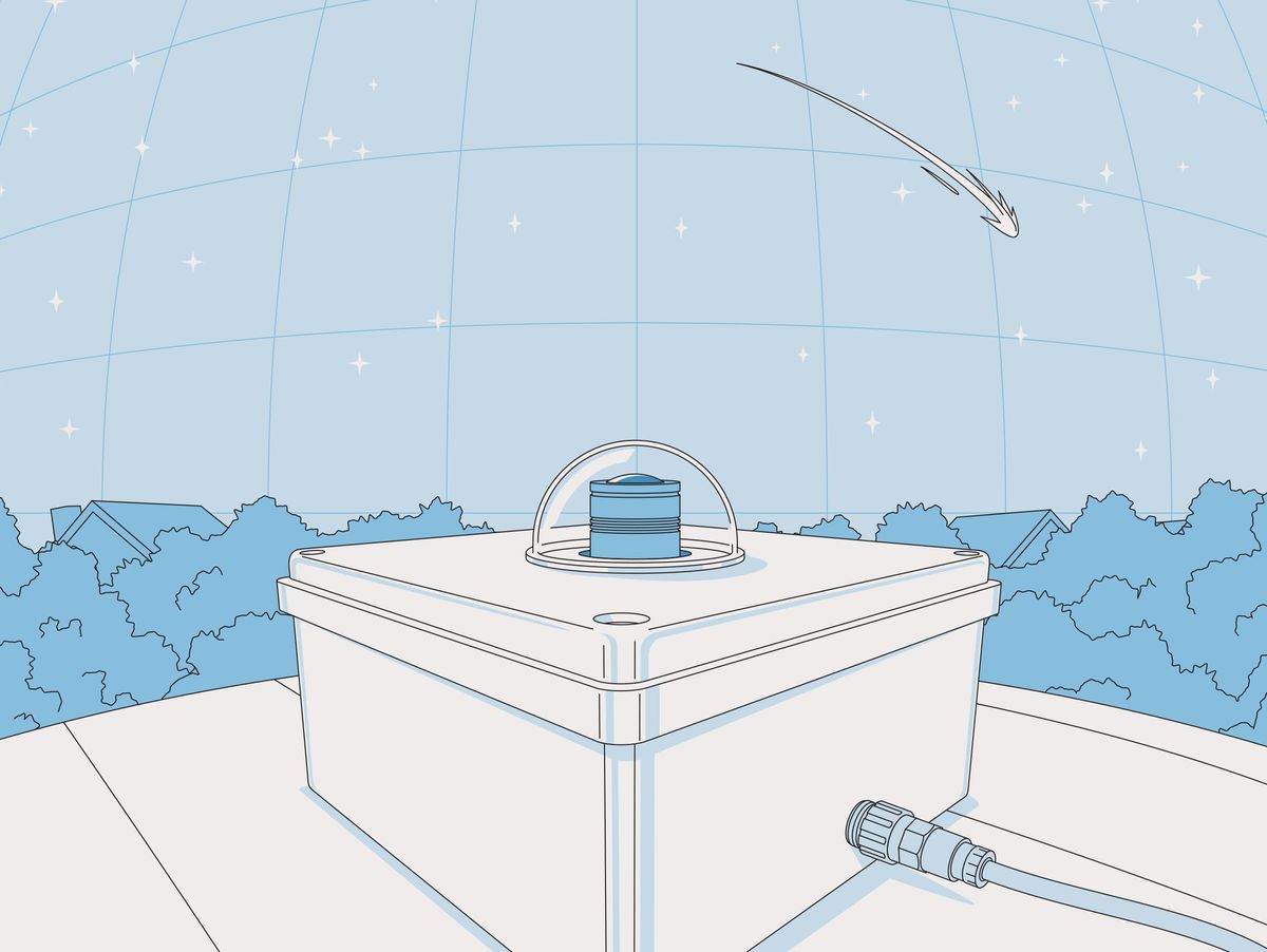 This illustration shows the camera, housed in a box, with the end of the lens poking out the top, covered by a transparent dome. Above the camera is a star-studded sky.