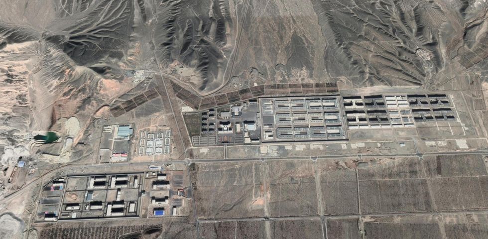 This image shows a sprawling compound of dozens of large buildings located in a desert area.