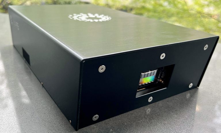 This photograph shows a black enclosure sitting on a table. Along one face of the box is an opening behind which the lidar chip is mounted.